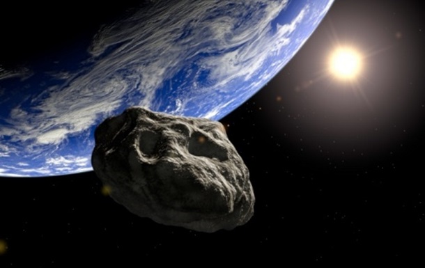 Астероид на фоне Земли.