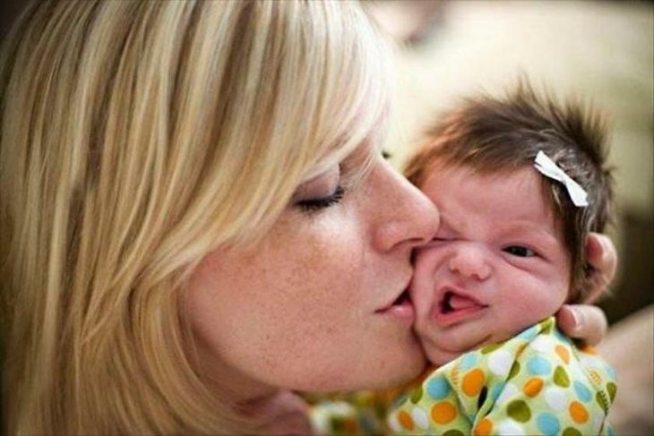 Мама целует новорожденного